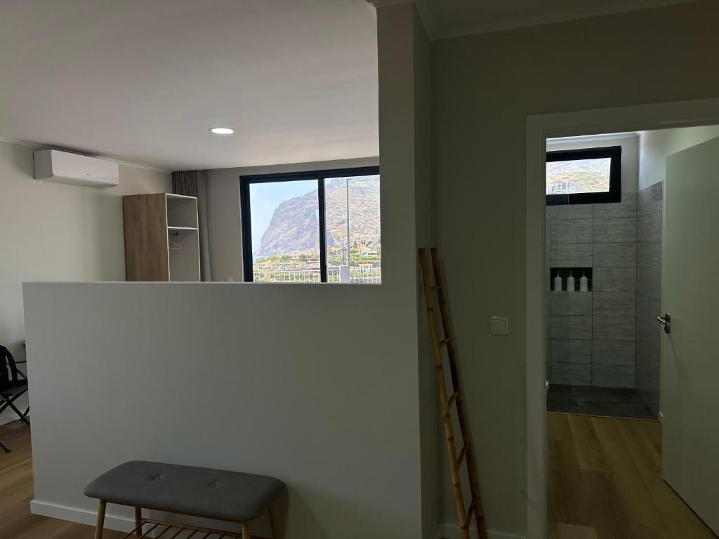 a bathroom with a view of a shower and a window at Oásis Suites - Funchal in Funchal