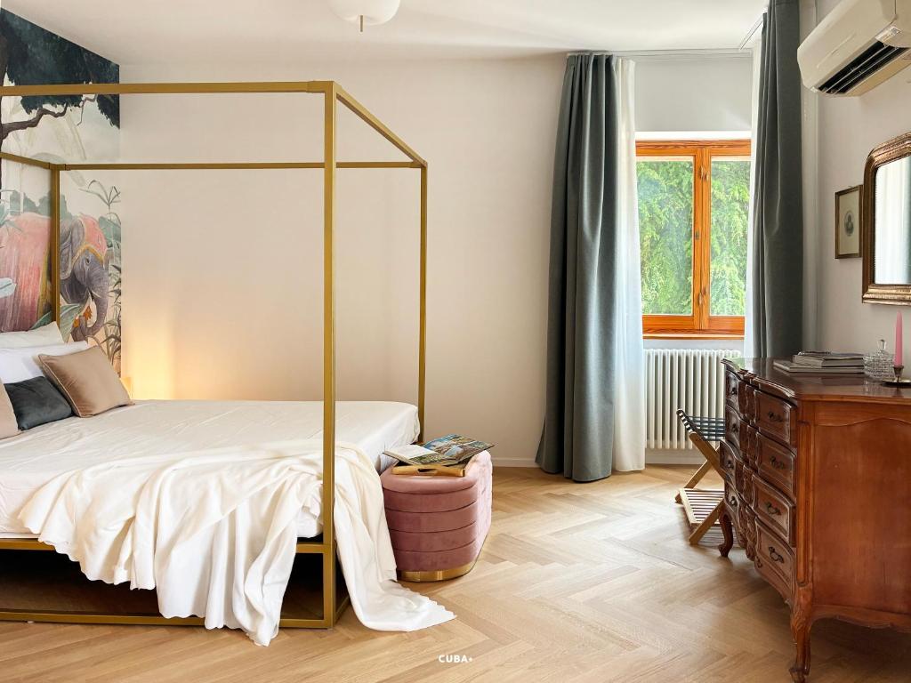 a bedroom with a canopy bed and a dresser at Villa Radici in Teramo