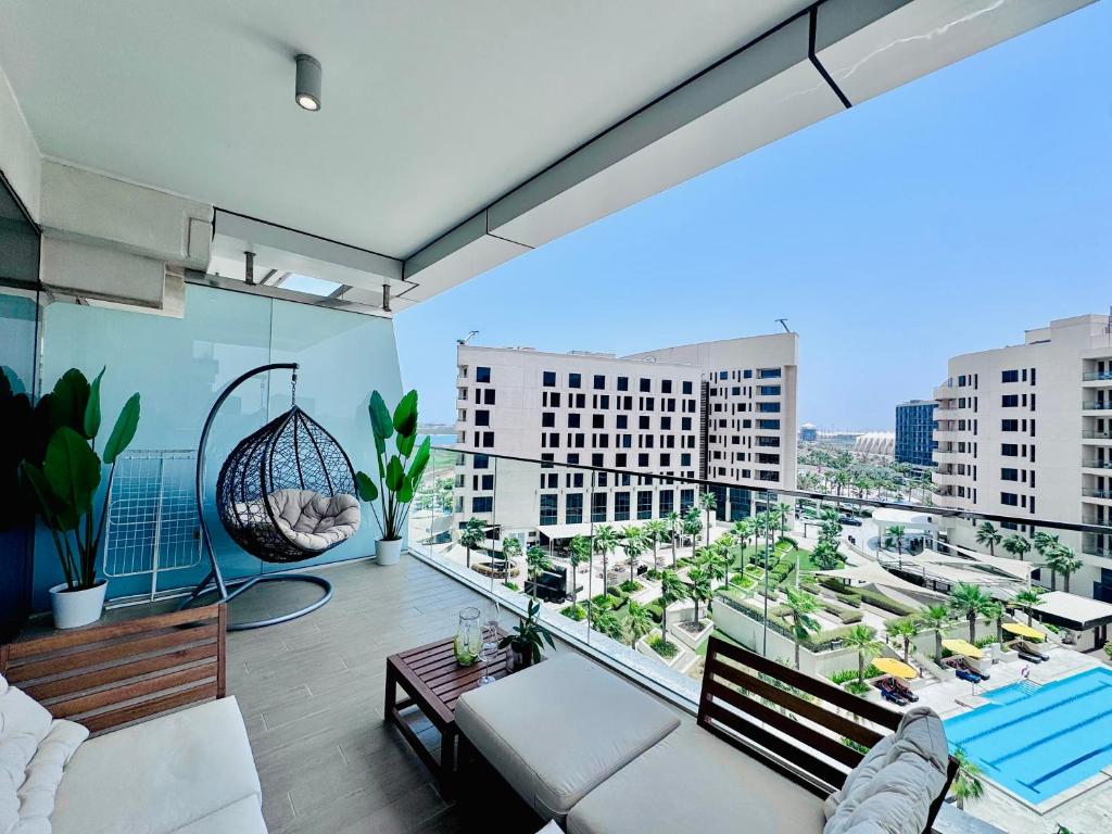 a living room with a view of a city at Circuit Views 1BR in Mayan 1 in Abu Dhabi