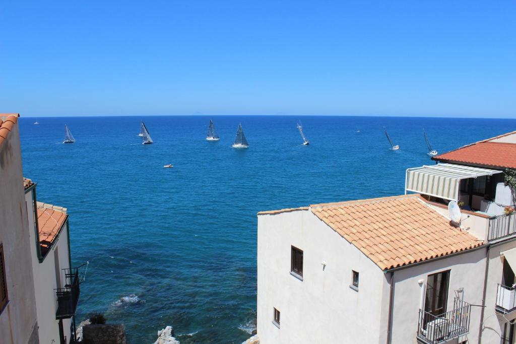 a view of the ocean with boats in the water at Gaia Holidays in Cefalù