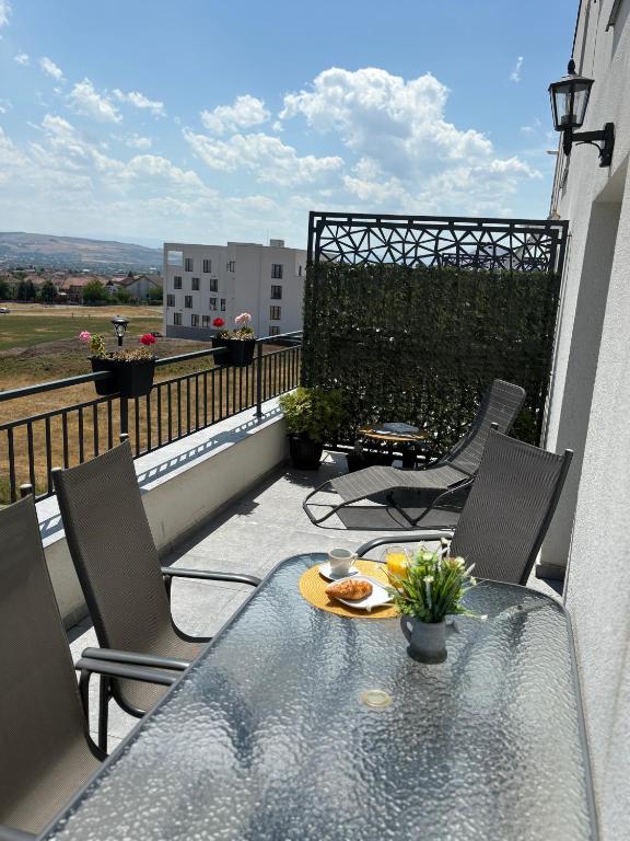 a table and chairs on a balcony with a view at APARTAMENT PANORAMIC in Alba Iulia