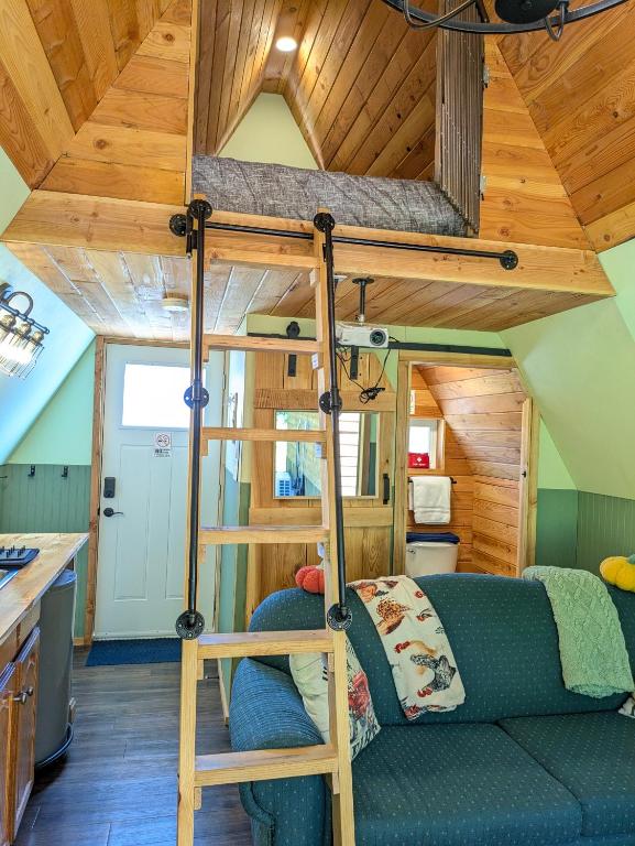 a room with a bunk bed in a tiny house at Farmhouse cabin on family farm in Powell River