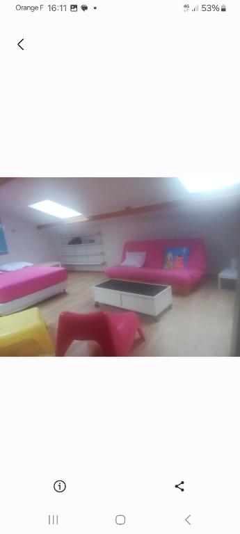 a room with a bed and a table and chairs at Vacances proche des sables d'olonne Vendée in Le Girouard