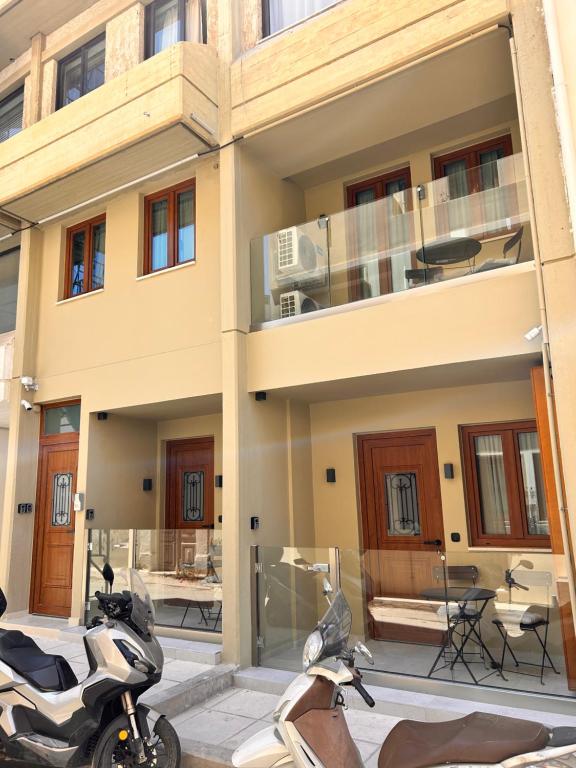 two motorcycles parked in front of a building at Quince city center 3 in Heraklio