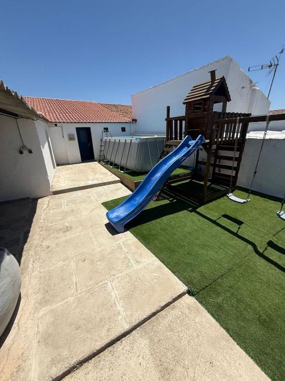 a slide and a gazebo on a patio at Santinho house 2 in Beja