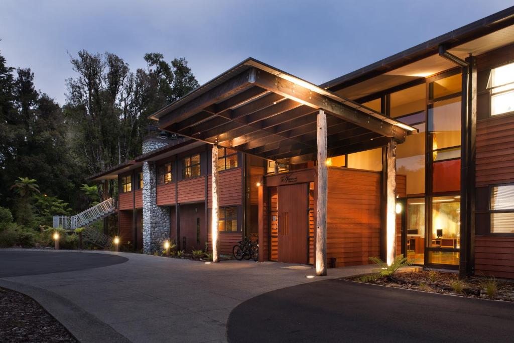 a house with a pathway leading to the front entrance at Te Waonui Forest Retreat in Franz Josef