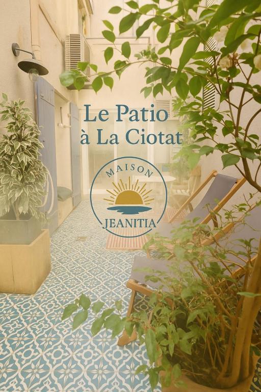 a sign for la patina a la gordita on a floor with plants at Le Patio in La Ciotat