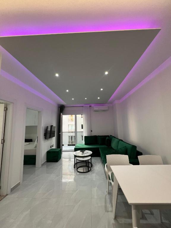a living room with a green couch and purple lighting at RbNb Shengjin in Shëngjin