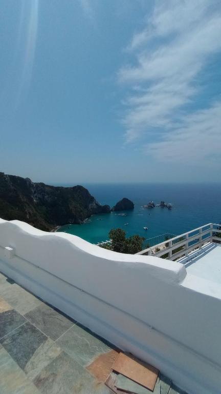 a view of the ocean from a white building at Le Case dei Pescatori - Casetta Faraglioni in Ponza