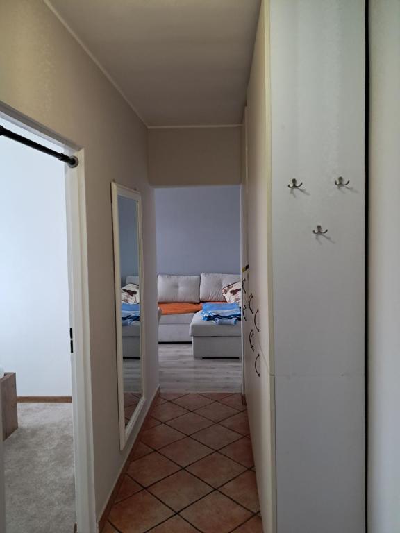a hallway with a bed and a mirror in a room at Noclegi Mieszkanie Kuchnia Żywiec in Żywiec