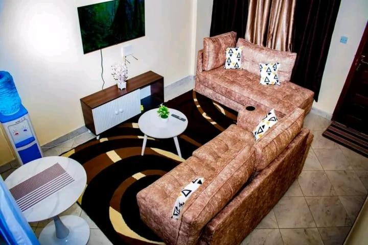 a living room with a couch and a table at Comfort and style in Nairobi