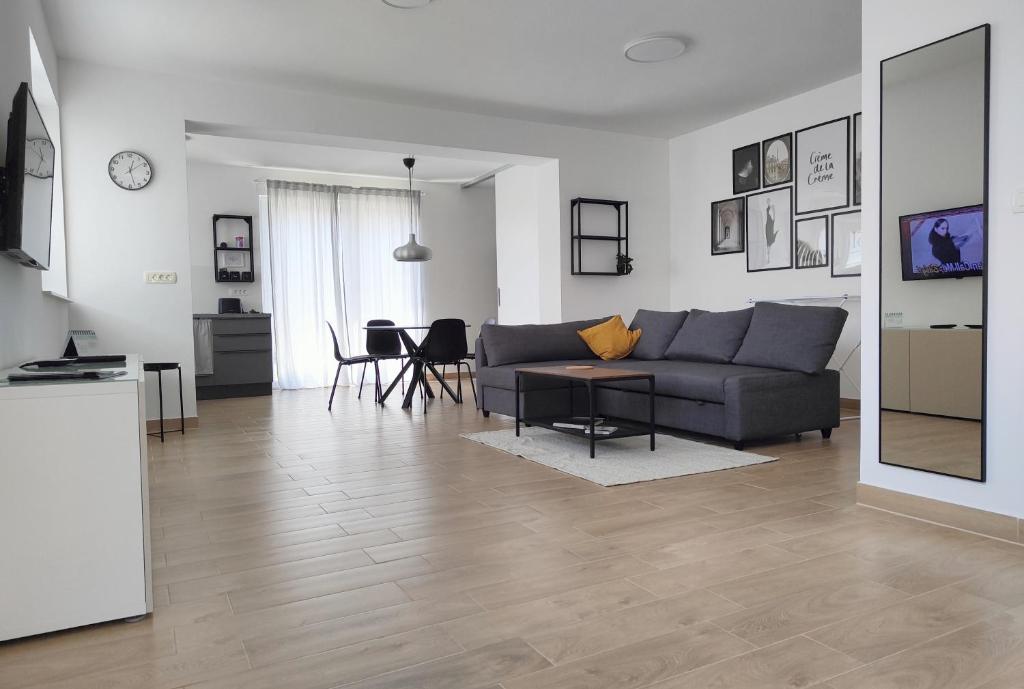 a living room with a couch and a table at Apartma WALK in in Brežice