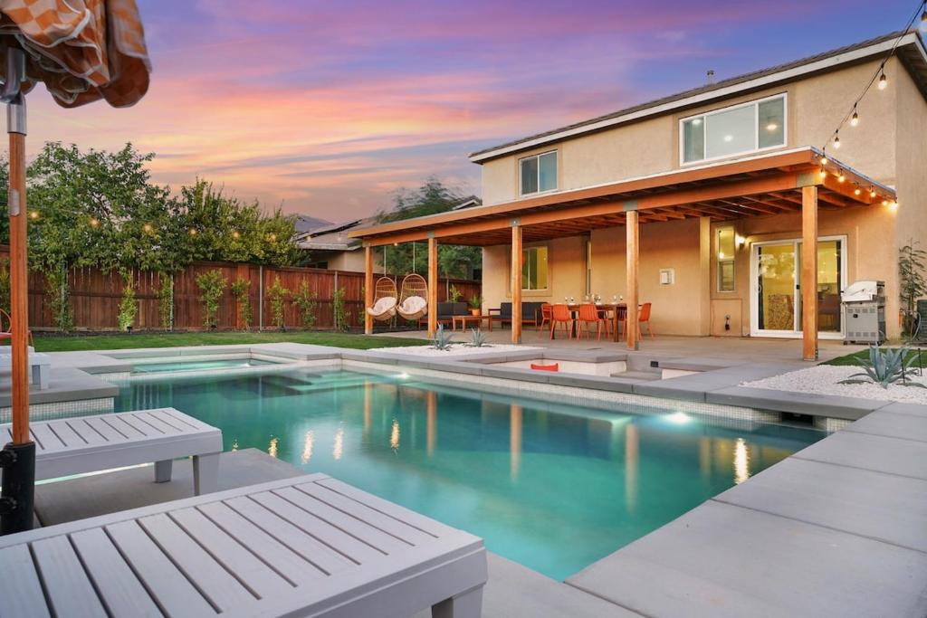 a house with a swimming pool in front of a house at Colorful house with Amazing Backyard in Coachella