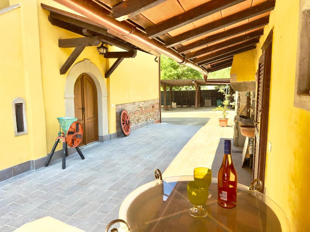 a table with a bottle of wine on a patio at Villetta di Sara tra Arezzo, Siena, Firenze e il Chianti in San Giovanni Valdarno