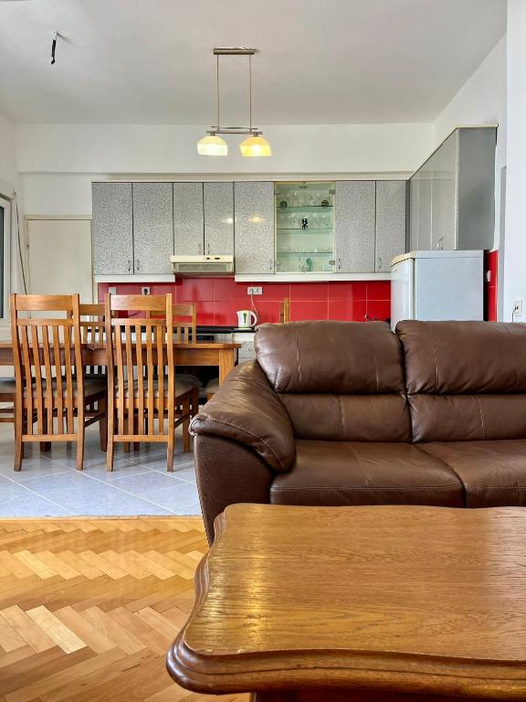 a living room with a couch and a dining room at Tivat Centar Apartment in Tivat
