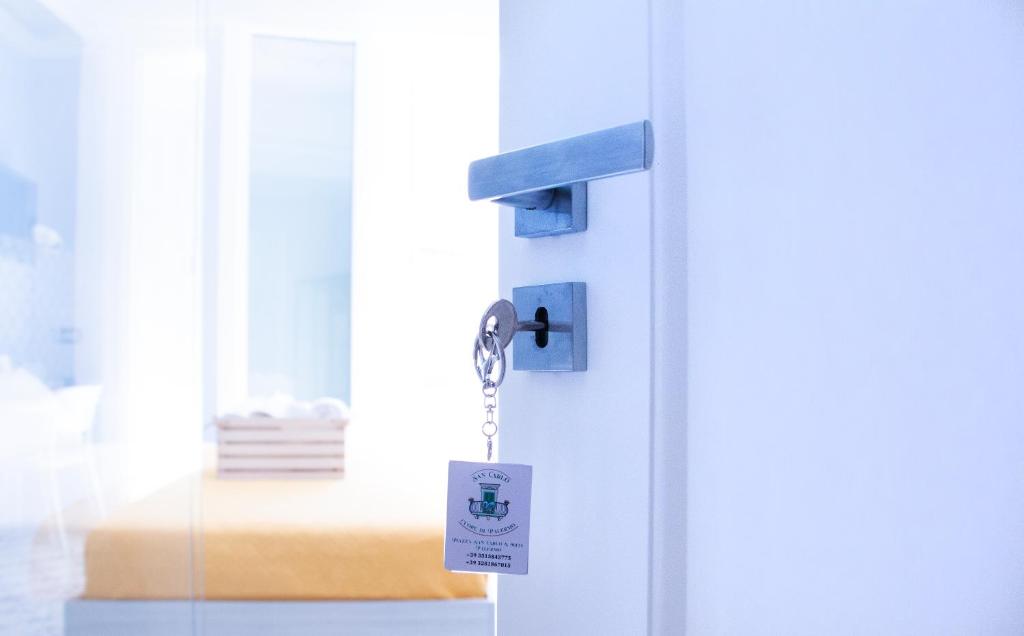 a door with a key tag attached to it at San Carlo Cuore di Palermo in Palermo