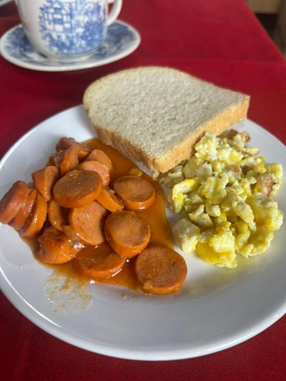 a plate of food with a sandwich and scrambled eggs at Hotel e Restaurante Casa Velha in Barra Longa