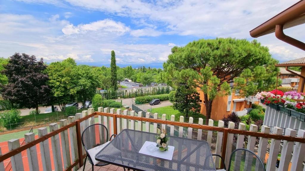 a table and chairs on the balcony of a house at Stay with us - BookingPeschiera in Peschiera del Garda