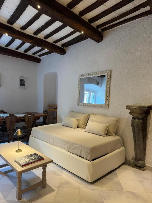 a bedroom with a bed and a table in it at La Casetta sul Porto in Porto Ercole