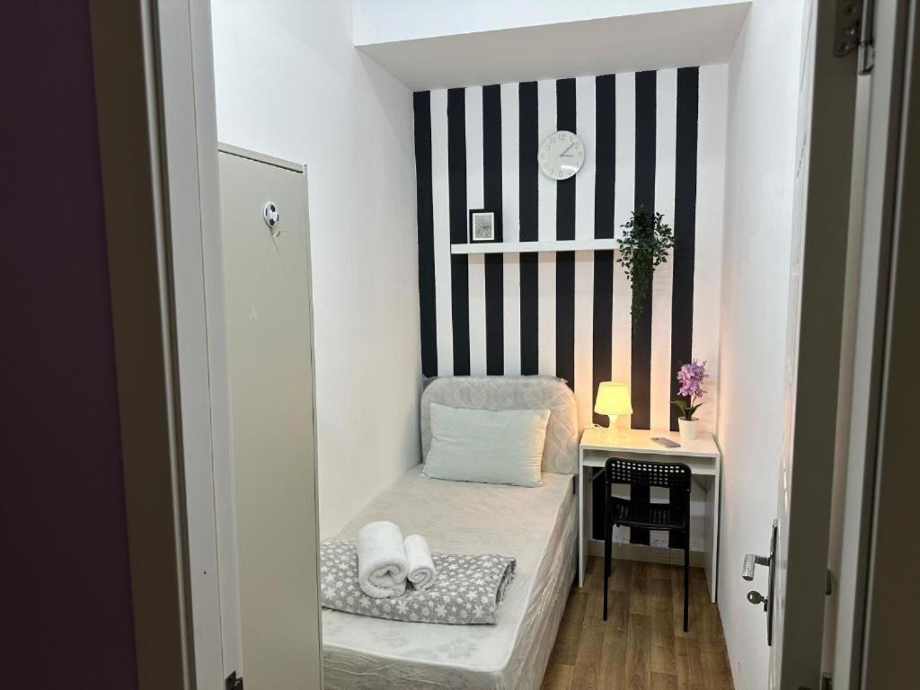 a small room with a chair and a table at Simple Stay Partition Room In Barsha heights Tecom in Dubai