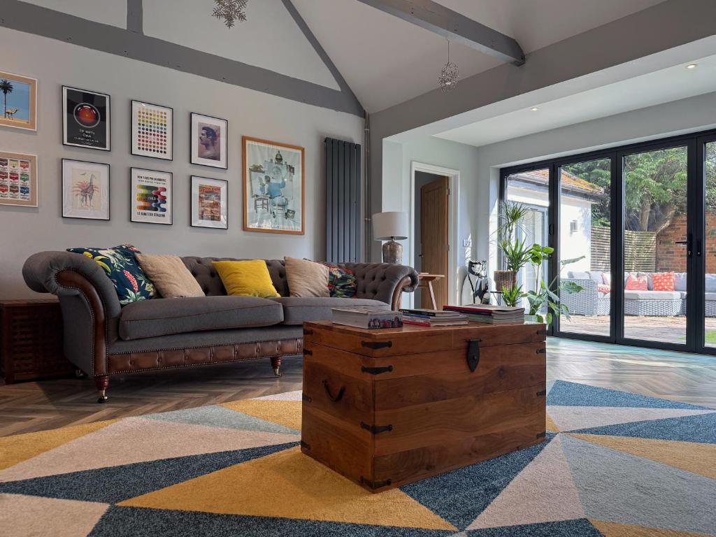 a living room with a couch and a coffee table at Historic Hampshire Cottage with Private Putting Green in Eversley