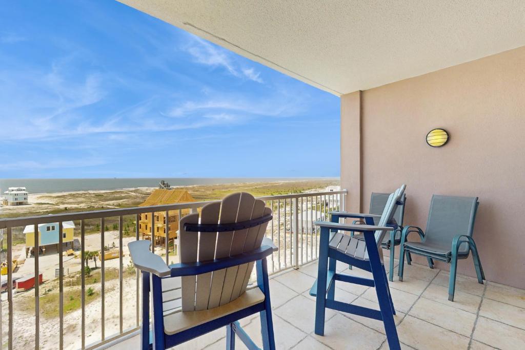 a balcony with chairs and a view of the ocean at The Dunes 704 in Gulf Shores
