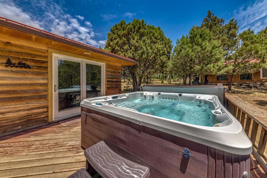 a hot tub on the deck of a house at Rustic Alto Cabin with Hot Tub, Deck and Fireplace! in Alto