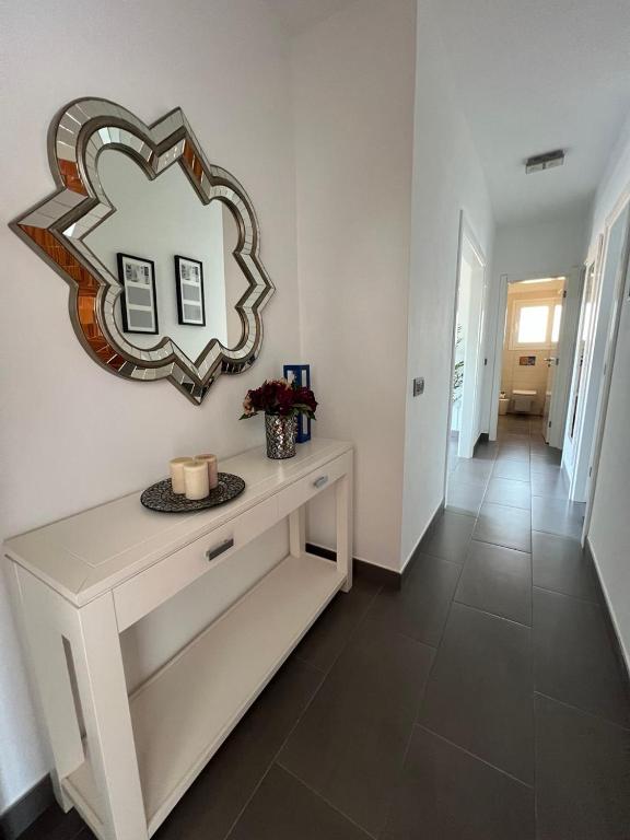 a room with a table with a mirror on the wall at Apartamento Celma in Adeje