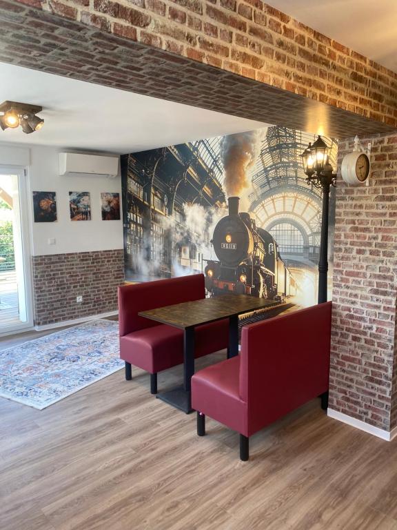 a dining room with a train mural on the wall at Le RiedExpress in Schwobsheim