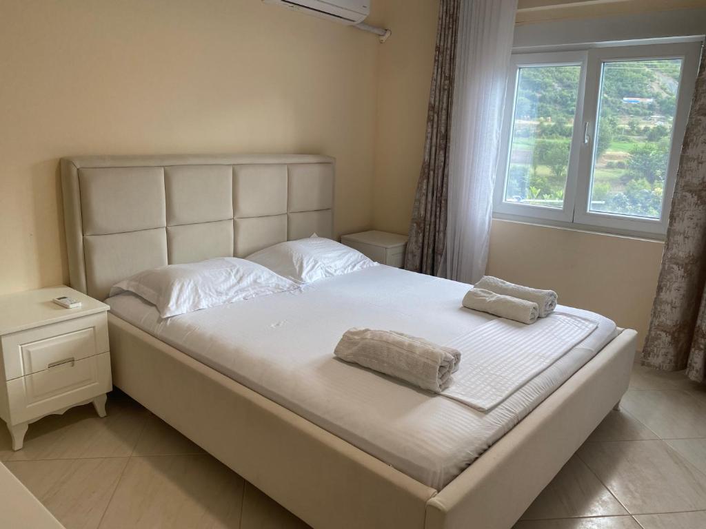 a bedroom with a bed with two towels on it at Vacation Home Kondi Ilia in Petran
