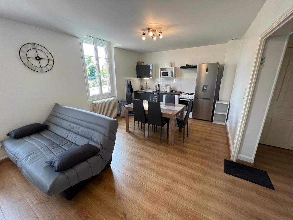 a living room with a couch and a table at PERLE RARE centre-ville in Paray-le-Monial