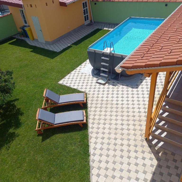 an overhead view of a swimming pool with chairs next to it at Apartman Cherry in Višnjevac