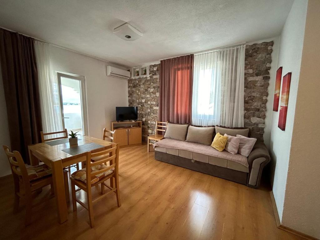 a living room with a couch and a table at Adriatic Breeze Family Stay in Trogir
