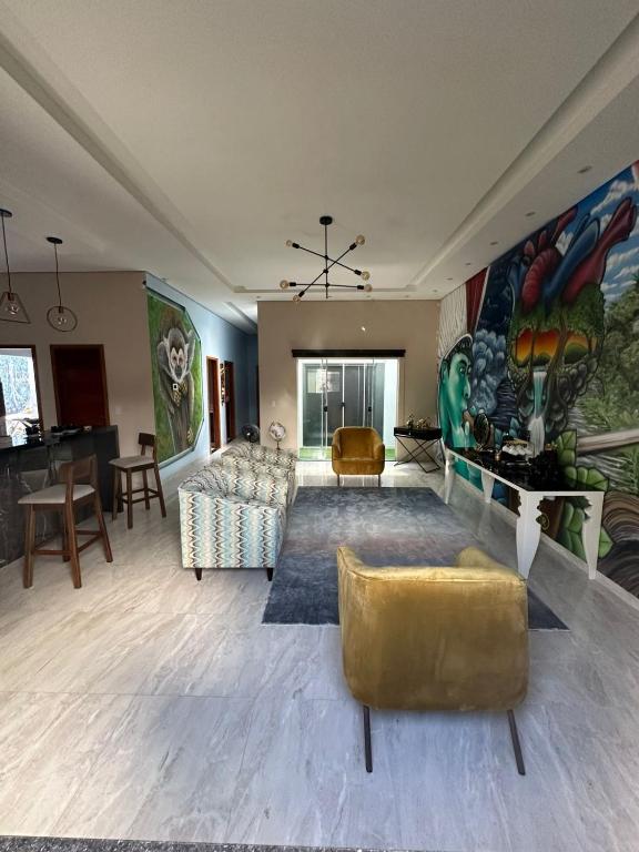 a living room with a large painting on the wall at AMAZON INn JACARÉ in Cruzeiro do Sul
