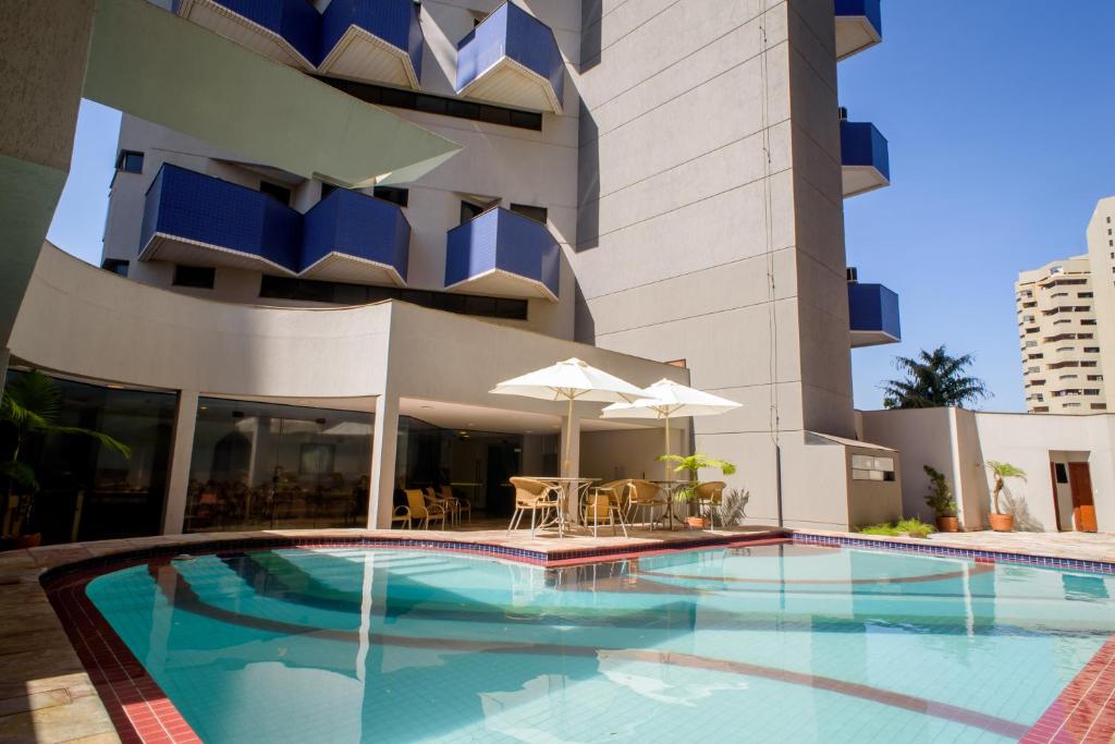 a swimming pool in front of a building at Bahamas Duplex by WS in Campo Grande