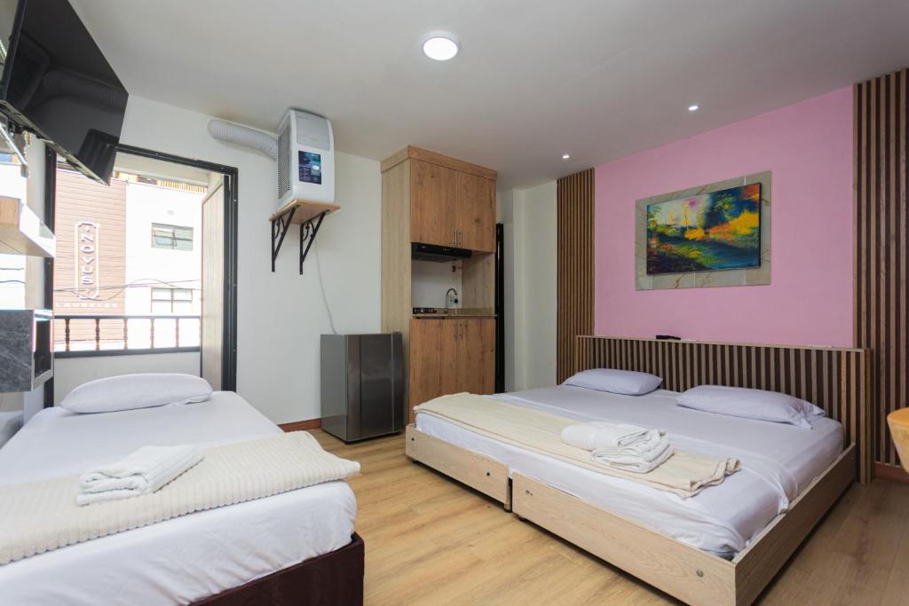 Postel nebo postele na pokoji v ubytování Hotel Lares 70 Laureles