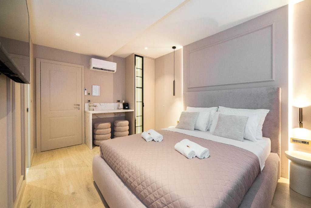 a bedroom with a large bed with towels on it at Good Grace Apartments in Zagreb