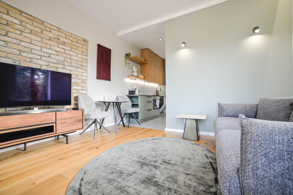 a living room with a couch and a flat screen tv at Homly S22 in Riga