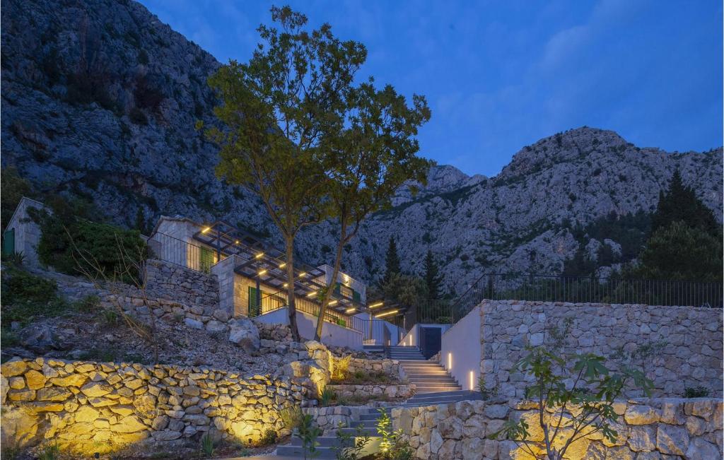 a stone house with stairs and a stone wall at Villa 2M in Makarska