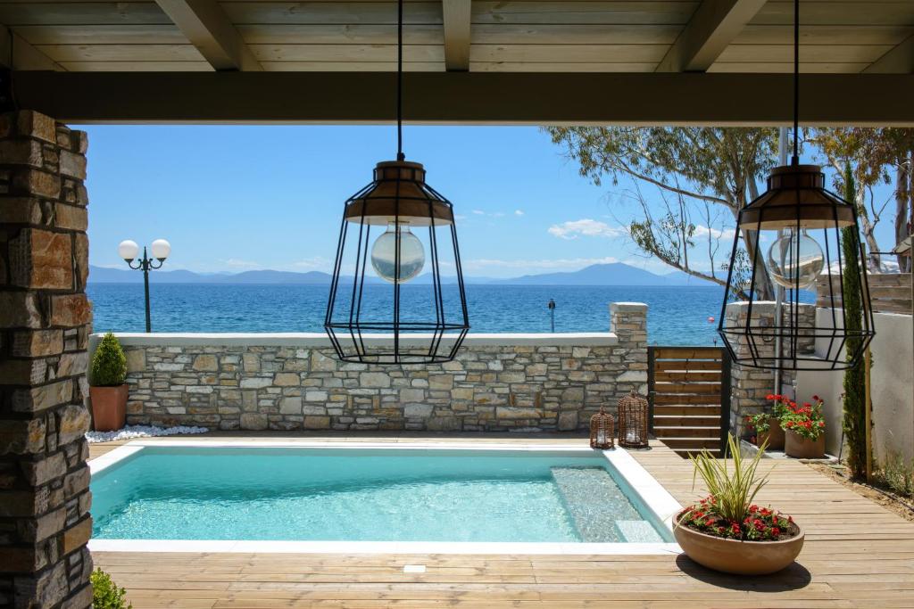 a swimming pool with a view of the ocean at Gatzea Villas in Kato Gatzea