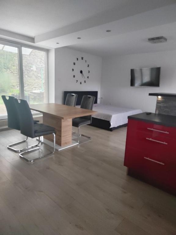 a room with a table and chairs and a bed at Ubytování Zdeňka in Chudenice