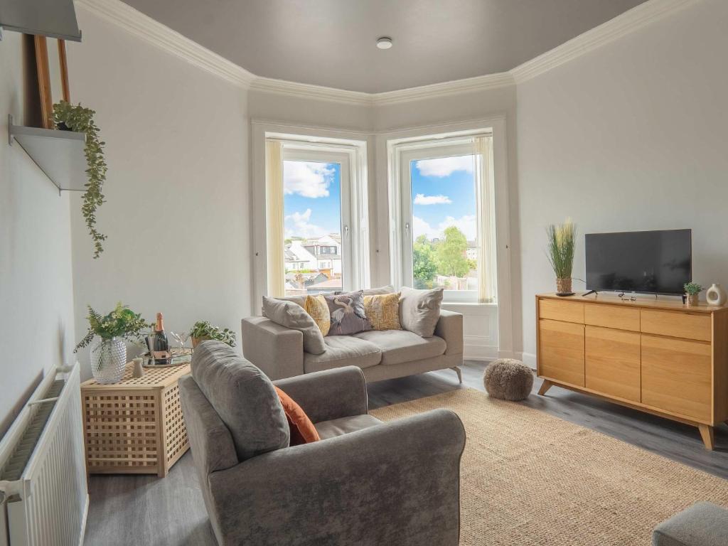 a living room with a couch and a tv at Pitchside Escape in Ayr