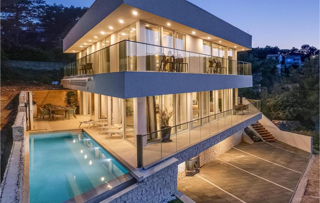 a house with a swimming pool in front of it at Villa Aestas in Vrboska