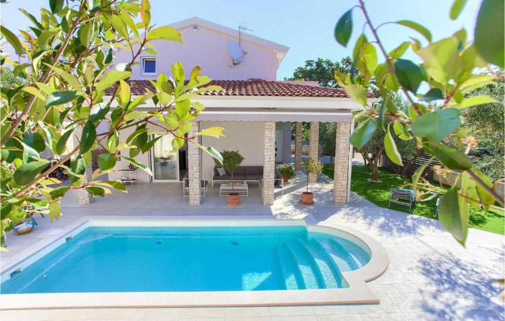 a swimming pool in front of a house at Villa Valentino in Kornić