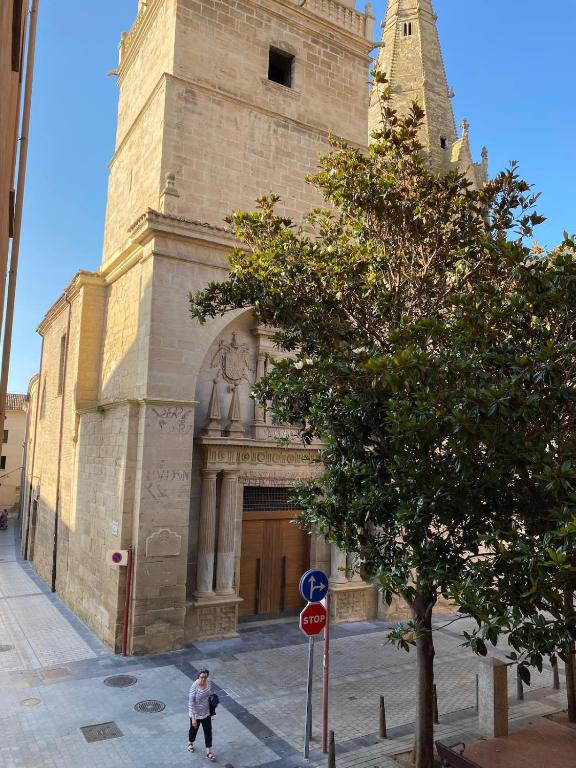 a man is walking in front of a church at De Palacio in Logroño