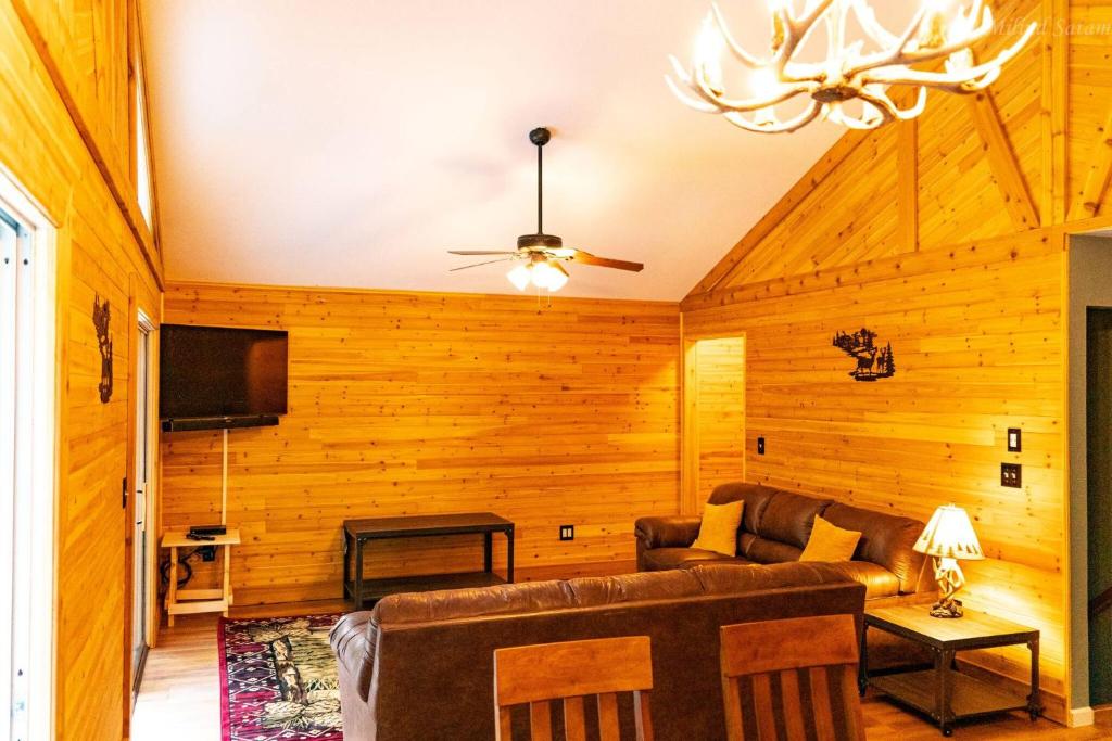 a living room with a couch and a tv at Deer Crest Cabin 5Bedroom near JFBB ski area/Lake in Towamensing Trails