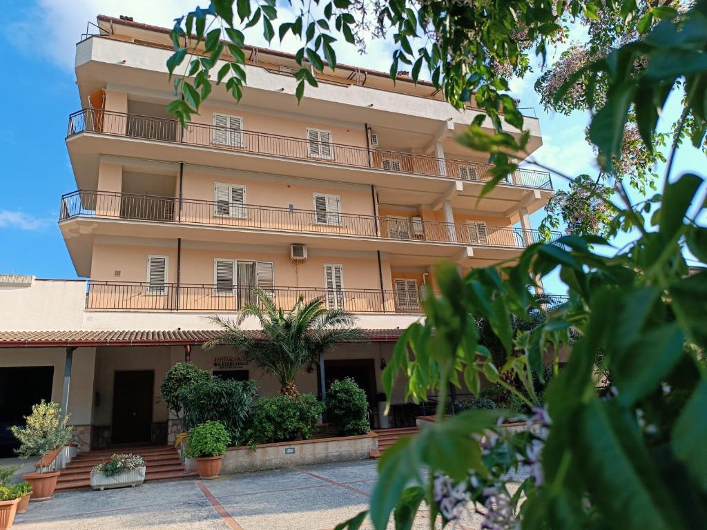 an apartment building with balconies and plants at Bilocale31 - stile e comfort a Frascineto in Frascineto