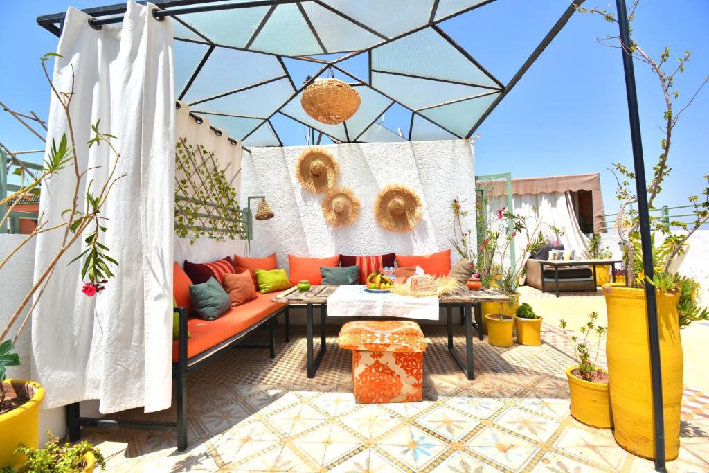 a patio with a couch and a table at Riad N57 in Marrakech