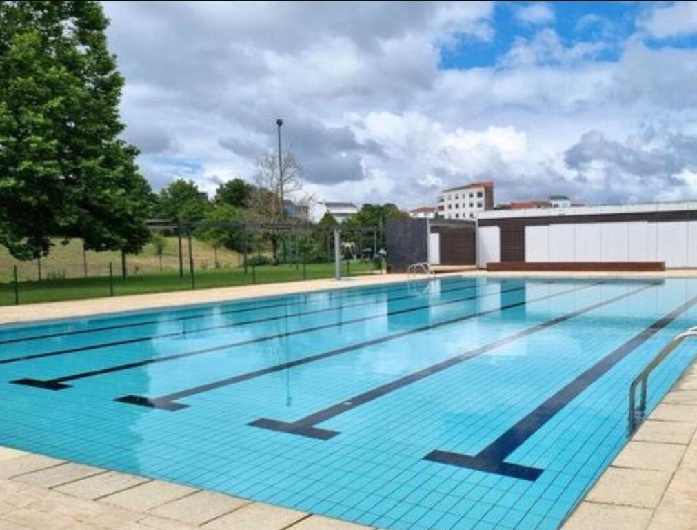 a large swimming pool on top of a building at Real 43 Buen camino in Neda