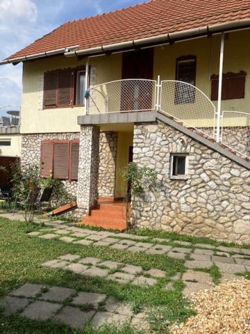 a house with a balcony on top of it at Fanni Aparmanház in Miskolc